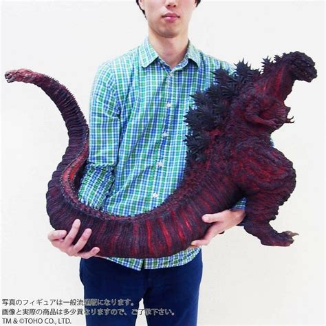 a man is holding an animal made out of yarn