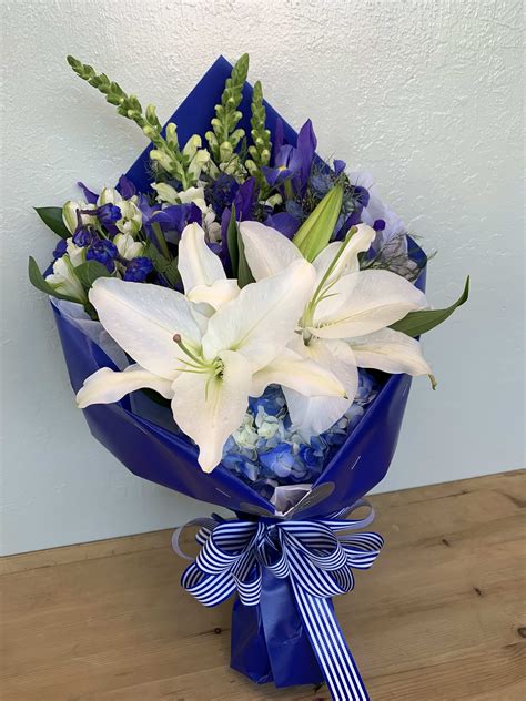 Blue & White Flowers Wrapped Bouquet by La Floriya