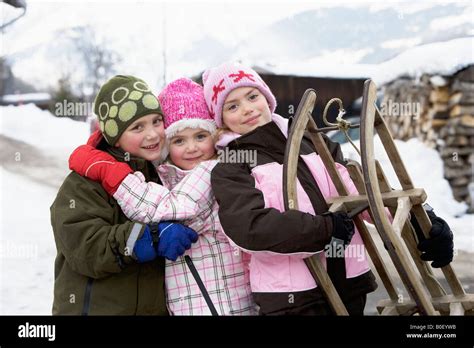 Portrait of children with sledge Stock Photo - Alamy