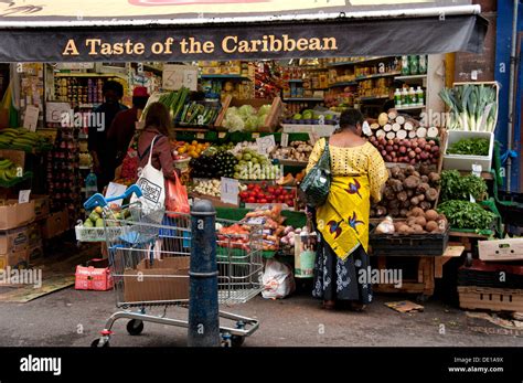 Brixton Market shops and stalls with multicultural fruit and veg Stock ...