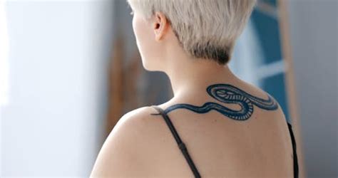 A Person's Back with Blue Tattoo · Free Stock Video