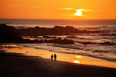 Couple Watch The Sunset At Carmel Beach by Pgiam