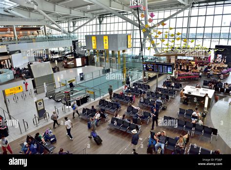 Inside Heathrow airport terminal 5 departures waiting area with seating ...