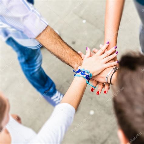 Group of friends holding hands in stack — Stock Photo © GiorgioMagini ...