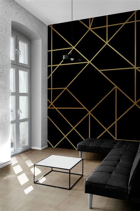 a living room with black and gold wallpaper next to a couch in front of ...