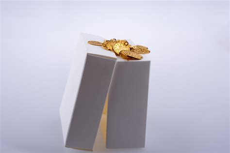 Fake gold coins in a box 14841879 Stock Photo at Vecteezy