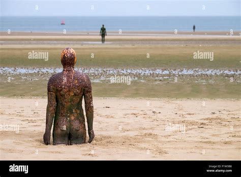 Antony Gormley sculptures Another Place on Crosby Beach Stock Photo - Alamy