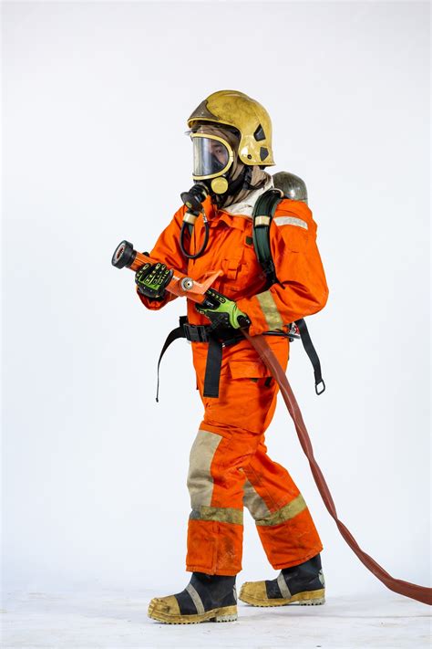 Premium Photo | Firefighter with axe in hands uniform and hardhat ...