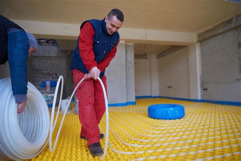 workers installing underfloor heating system 11603330 Stock Photo at ...