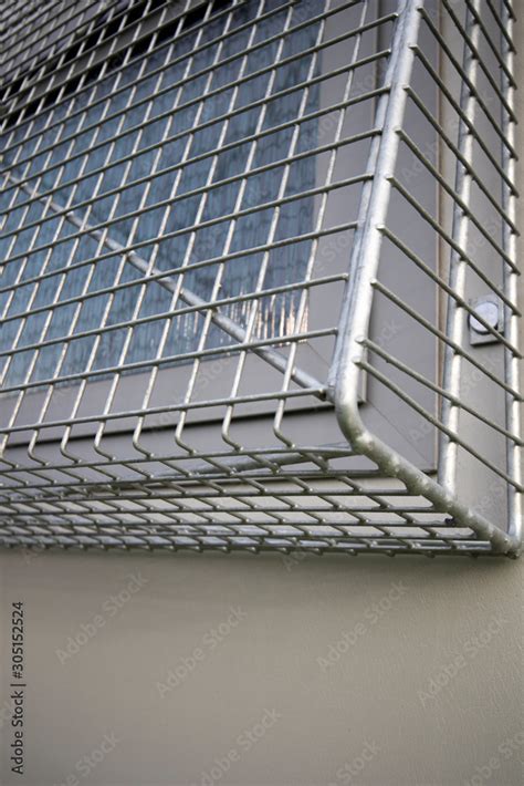 Window security wire mesh frame fixed externally to building wall to ...