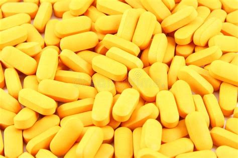 Yellow Pills Background. Background pattern of many oblong yellow pills ...