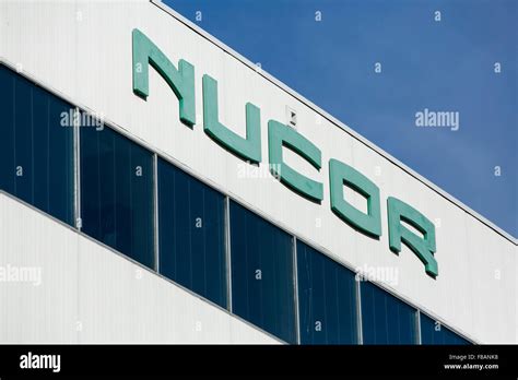 A logo sign outside of the headquarters of the Nucor Corporation in ...