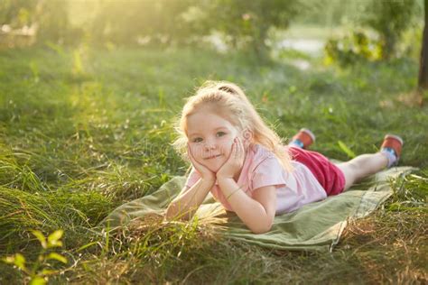 Little Girl is Lying on the Grass Stock Image - Image of colours ...