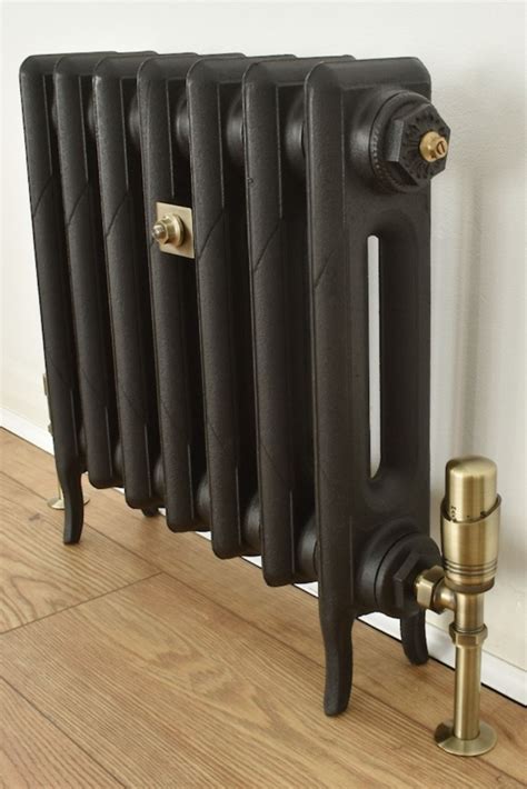 Black cast iron radiator with antique brass valves and fittings ...