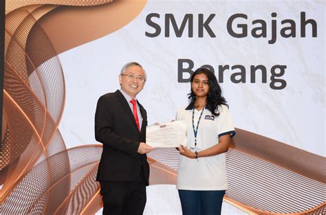 Prof Dato’ Ewe (left) presenting the scholarships to students in Kampar ...