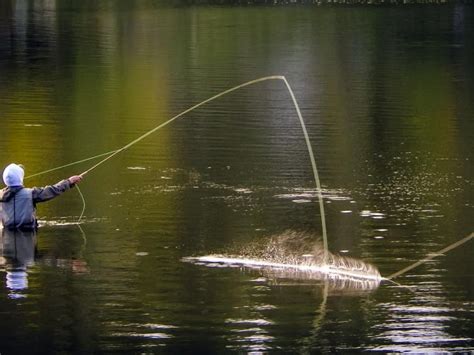 a man is fishing in the water with a net