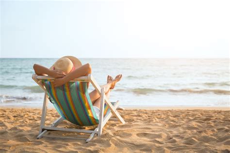 Woman Relaxing At The Beach On A Beach Lounge, Beach Vacation Concept ...