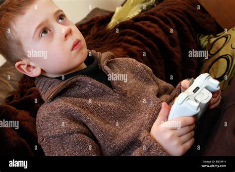 young boy playing holding remote controls for XBox 360 Stock Photo - Alamy