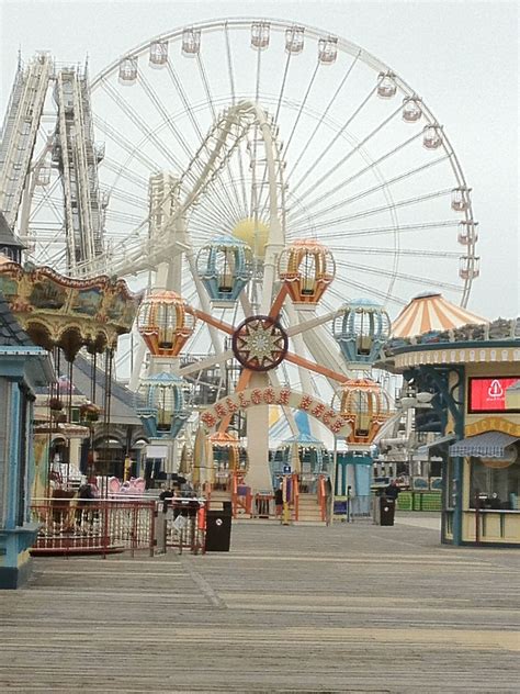 an amusement park with ferris wheel and rides