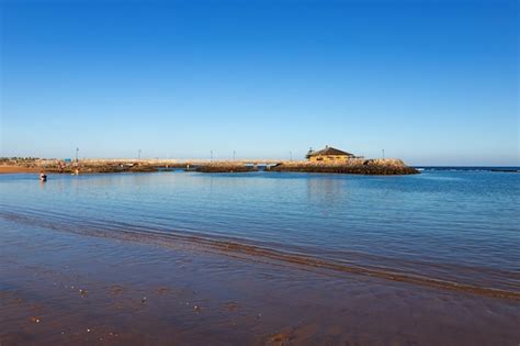 Premium Photo | Caleta beach with small pier