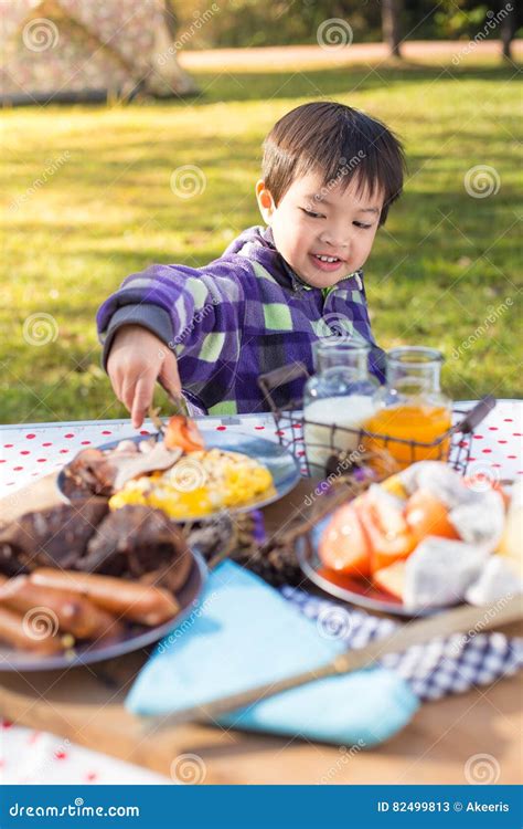 Young Boy Enjoying Breakfast Stock Image - Image of cute, outdoor: 82499813