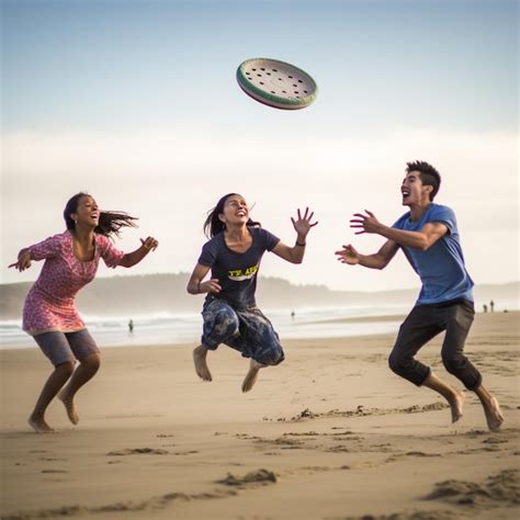 Premium Photo | A man and woman playing frisbee on a beach with the ...