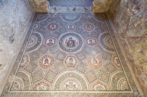 an ornate mosaic floor in the middle of a room with stone walls and ...