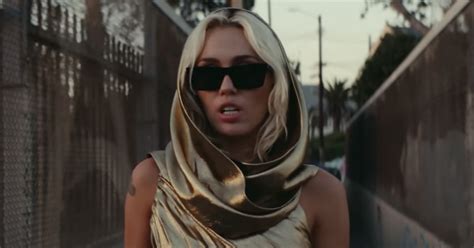 Miley Cyrus Wears Gold Cutout Dress in "Flowers" Music Video | POPSUGAR ...