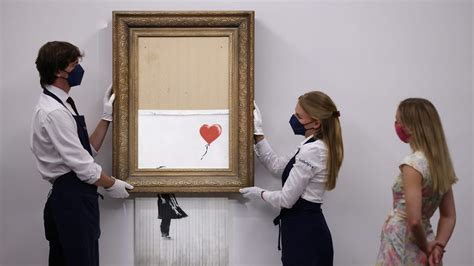 Banksy's shredded painting sells for record $25.4 million