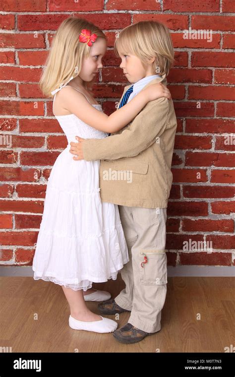 Little boy hugging a beautiful girl. Love concept. Series Stock Photo ...