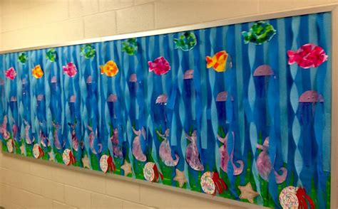 an art project is displayed on the wall in front of a school hallway ...