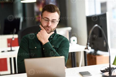 Young man studying with laptop computer on white desk. 4835569 Stock ...