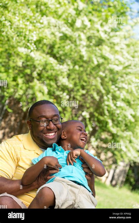 Father hugging his his son Stock Photo - Alamy