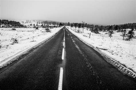 Premium Photo | Black road in snow