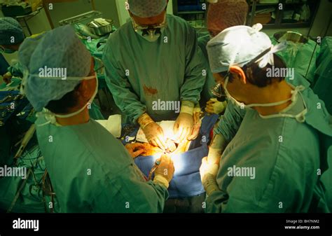 A surgeon performs open heart surgery during a procedure at the private ...