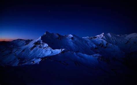 Snow-Covered Mountain at Night Wallpaper