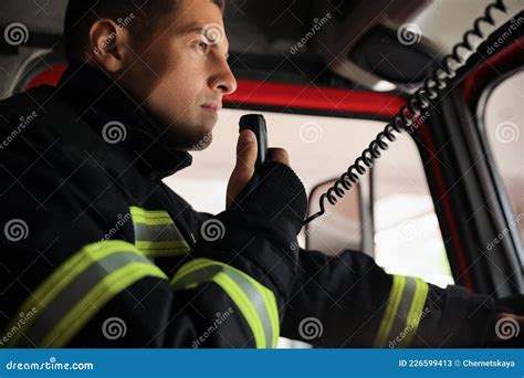 Firefighter Using Radio Set while Driving Fire Truck Stock Image ...