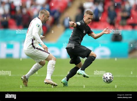 England's Luke Shaw (left) and Germany's Joshua Kimmich battle for the ...