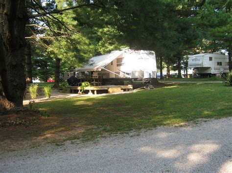 an rv park with picnic tables and parked campers