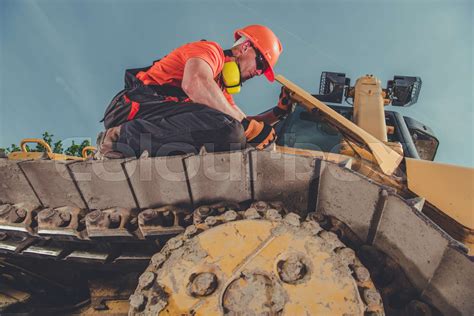 Bulldozer Operator Checking the Track | Stock image | Colourbox