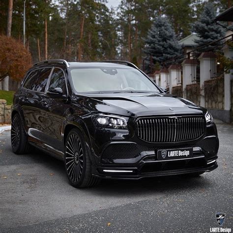 a black suv parked in front of a house