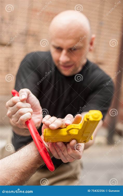 Gun Disarm. Self Defense Techniques Against a Gun Point. Stock Photo ...