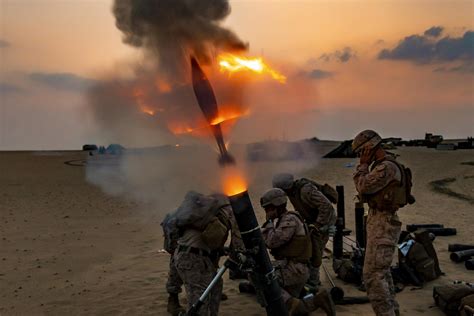 U.S. Marines fire a 120 mm mortar round during a live-fire training in ...