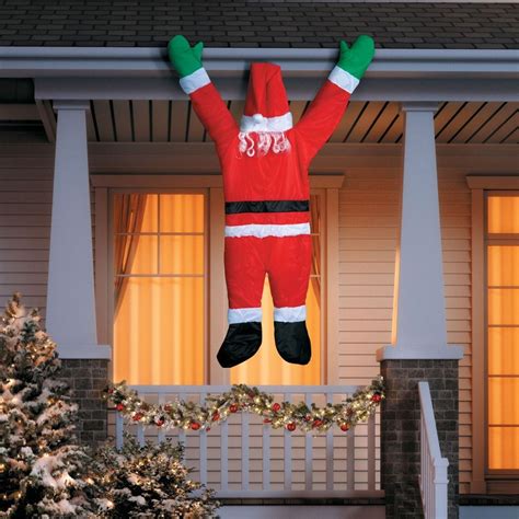 This outdoor Christmas decoration makes it look like Santa is hanging ...