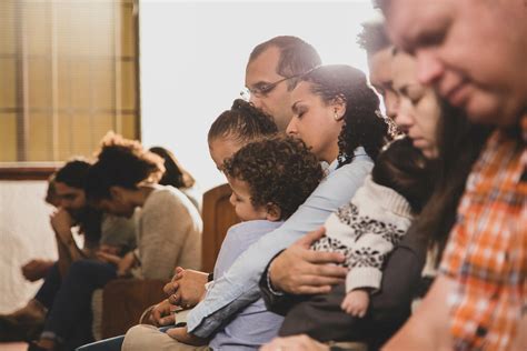 Congregation Members Praying Together - Church stock photos - Logos Sermons