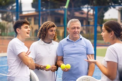 Two Pairs of Padel Players are Happily Discussing Past Game on an Open ...