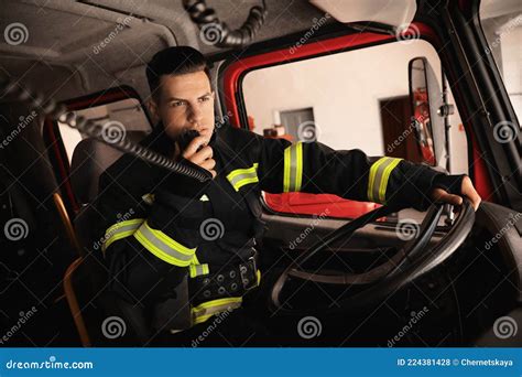 Firefighter Using Radio Set while Driving Fire Truck Stock Photo ...