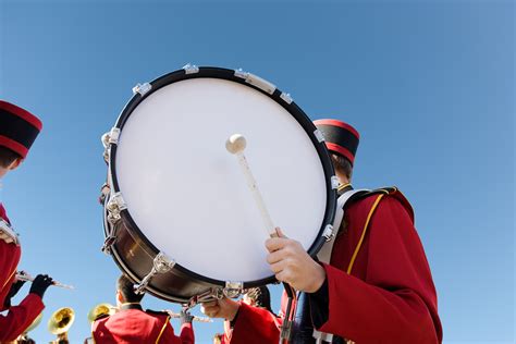 Bass drum of marching band being held by band member in uniform against ...