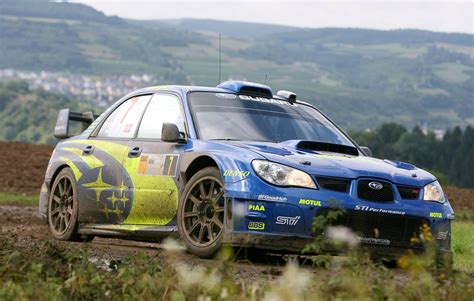 a subarun car driving on a dirt road