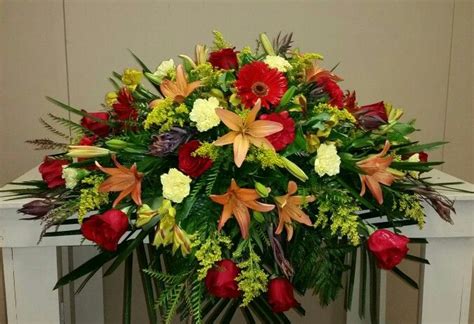 Fall colored casket spray designed at The Lumberton Flower Shop Funeral ...